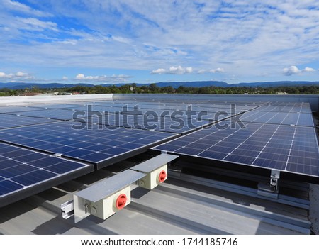 Solar Panels on Flat Roof Blue Sky with light Clouds in V formation and two Isolatior Switches