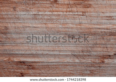 Texture of Old and used natural wooden cooking board with cuts background. Background of old wooden cutting board