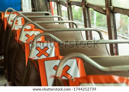 Orange X symbol is attached to the public bus seats in Bangkok. To allow 1 passenger to sit in each seat To keep the social distance during the Coronavirus or Covid-19 pandemic.