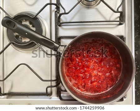 Making a strawberry jam. Boil strawberries in the pan. Texture fruit, strawberry jelly. Do it yourself process, homemade food. 
