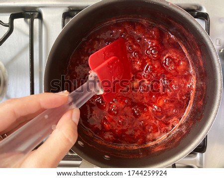 Making a strawberry jam. Boil strawberries in the pan. Texture fruit, strawberry jelly. Do it yourself process, homemade food. 