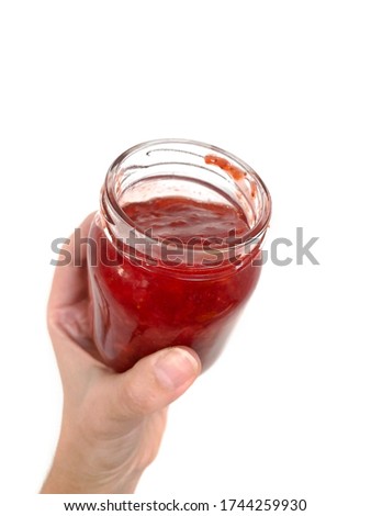 Homemade strawberry jam in a glass jar over white background. Texture fruit, strawberry jelly. Do it yourself process, homemade food. 