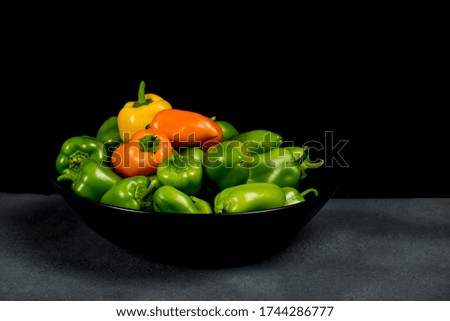 green and orange peppers on timeless still life