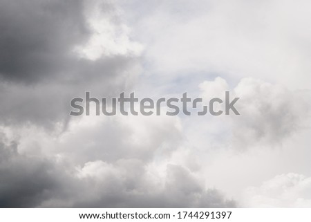 Gray clouds in the pale sky. Beautiful gray and white cloudy rainy sky