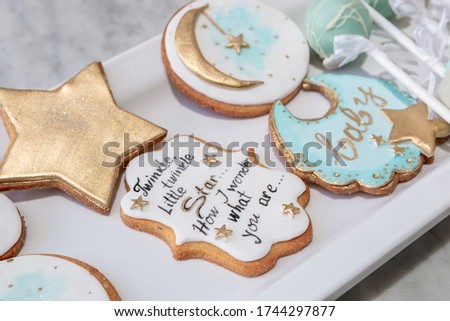 Various shapes gingerbread cookies on white tray, served for baby shower party. Royalty-Free Stock Photo #1744297877