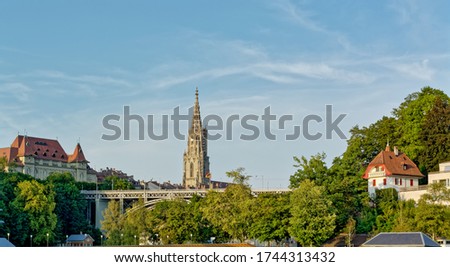 View of Kirchenfeld bridge over the river Aare, with Cathedral in the background, in Bern, Switzerland