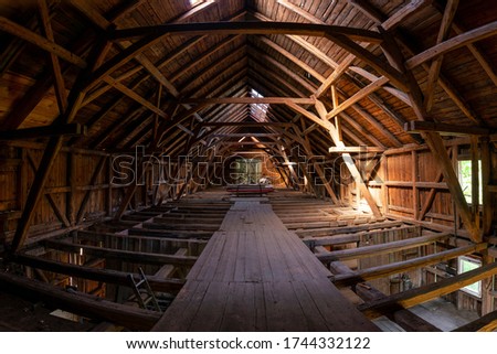 Interior of large old timber frame barn in Germany during renovation, upper floor wide angle shot Royalty-Free Stock Photo #1744332122