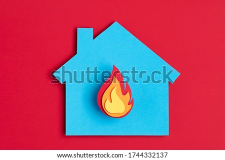 Papercut house with fire inside. Home insurance, security, safety, damage, accident prevention concept
