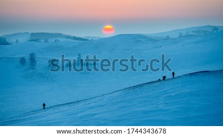 Chinese Photographers love filming sunset and sunrise. Photo taken on China Highland Bashang, Mongolian Minority Plateau. Winter Landscape Snow View.