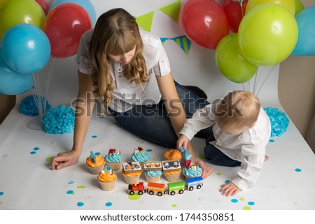 the son feeds his mother a holiday cupcake . birthday of the child