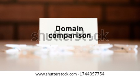 Domain comparison - seo text of business concept on white list and with clothespins