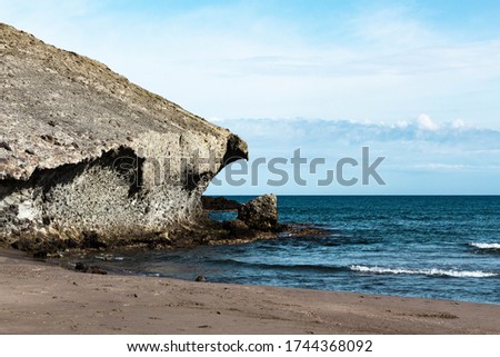 Monsul Beach, on the left, a large volcanic rock, featured in movies like Indiana Jones and the Last Crusade. Royalty-Free Stock Photo #1744368092