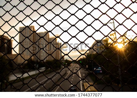 
the flow of moving cars through a metal mesh cube urban landscapes wallpaper city road with cars through the mesh