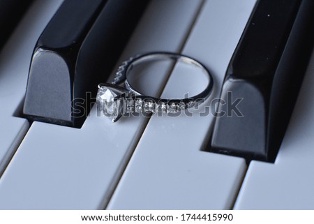 Beautiful wedding ring on piano keyboard in close-up