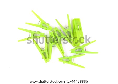 green  plastic Clothespin isolated on white background