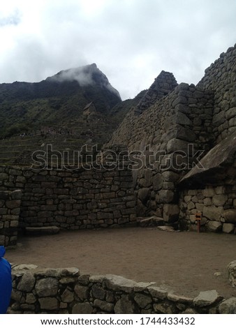 Close-up photo of the ruins of the archaeological site of Machu Picchu with the Andes seen from above, Peru.