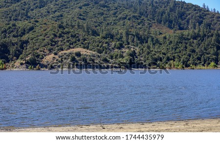 View of a person fishing in a boat at Lake Hemet in California.