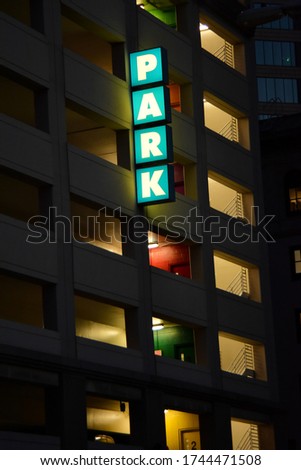 San Diego parking garage in downtown lit up at night with interesting color rooms.