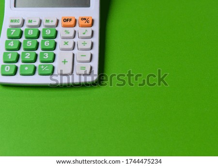 calculator isolated green background. How to calculate the budget of living