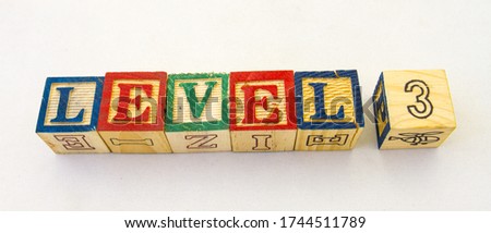The term level 3 visually displayed on a clear background using colourful wooden toy blocks image with copy space in horizontal format