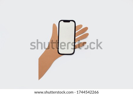 Paper art and craft hands hold phone. Finger touches screen. Isolated background. Cutting.