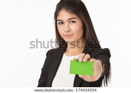 A portrait of an Asian Woman in business formal black suit holding a green blank name card with her fingers. Isolated on white background. Close up half body.