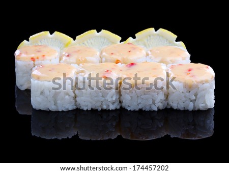 Spicy sushi set with lemon on black background