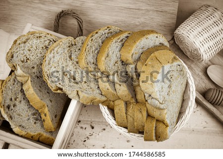 Fresh whole wheat bread cut into pieces, arranged in baskets and wooden backdrop.