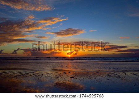 Vibrant colours beautiful ocean sunset at Kuta beach, Bali, Indonesia
