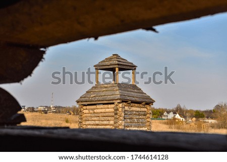 wooden fortress in the field, old Russian wooden structure, village tower in the field, ancient Russia