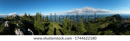 beautiful landscape seen from top of the green mountain in summer season. horizon line on sunny day with blue sky and fluffy clouds