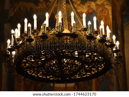 church ceiling candelabrum, candelabra with candles, ceiling candelabrum close-up Royalty-Free Stock Photo #1744623170