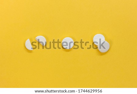 A set of round tablets. The view from the top. Isolated on a yellow background.