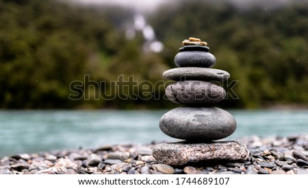 Stacked Rocks in front of Waterfall Royalty-Free Stock Photo #1744689107