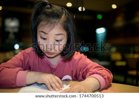 A portrait of a lovely asian girl in a restaurant
