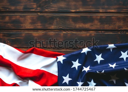Flag of the United States on  brown  wooden  dark  table. Copy space. 