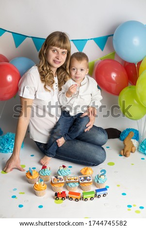the son feeds his mother a holiday cupcake . birthday of the child