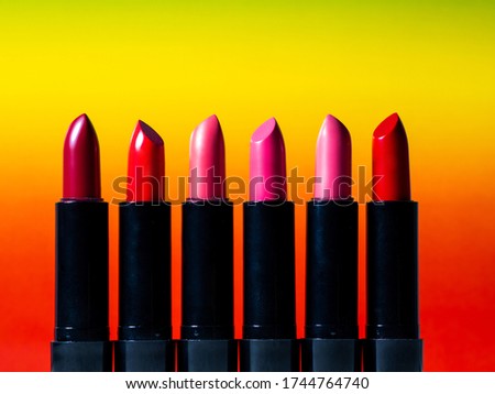 set of six multi-colored lipsticks or lip glosses. set of makeup artist, beauty and cosmetics for every day