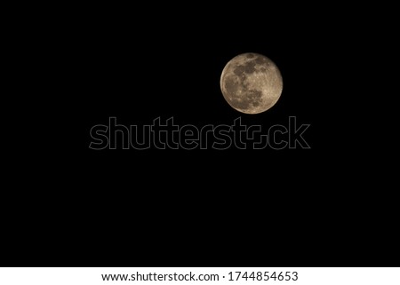 Full yellow moon in the night starry sky