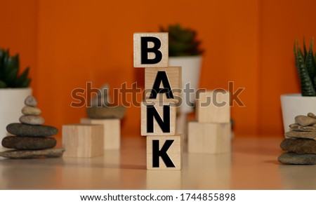 Word BANK made with wood building blocks on a gray background