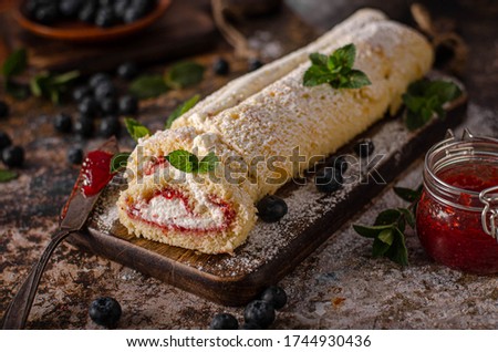 Sweet creamy roulade with berries, forest fruit and mint