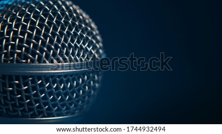 Macro shot of a stage mic professional vocal microphone - black background