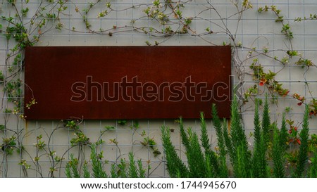 cement wall with red iron plate hanging