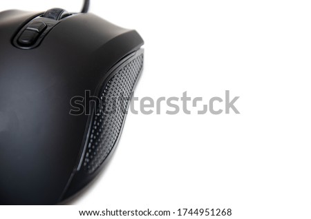 Black gaming mouse with side extra keys and  matte finish on white background. Mouse view from the back under the brush. The mouse in macro, the keys and the wheel are viewed from a person at an angle