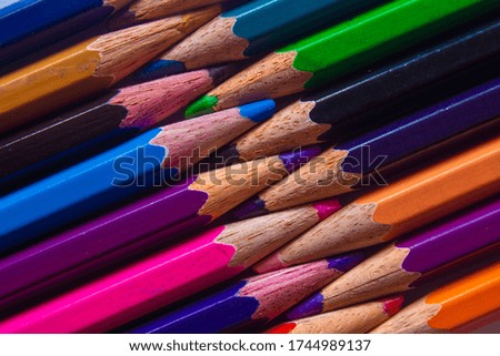Color pencils arranged in a creative way. Student art supplies.