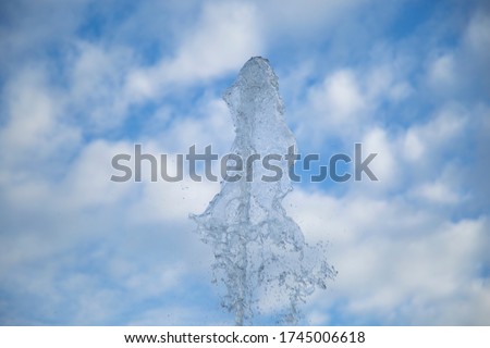 Clean and artesian water from the well. A stream of water against the sky. Royalty-Free Stock Photo #1745006618