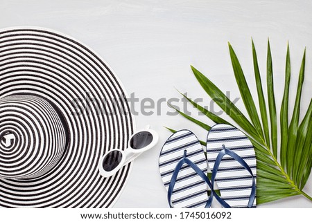 Summer vacation, travel, tourism concept flat lay. Tropical beach accessories top view with hat and flip flops