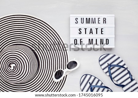 Summer vacation, travel, tourism concept flat lay. Tropical beach accessories top view with light box with text Summer State of mind