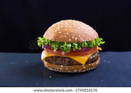 Beef burger with cheese, tomato, red onion, lettuce 