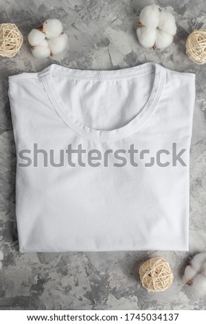 Layout with a white T-shirt Flat lay with cotton flowers, soft and light photo. For placing fonts, logos